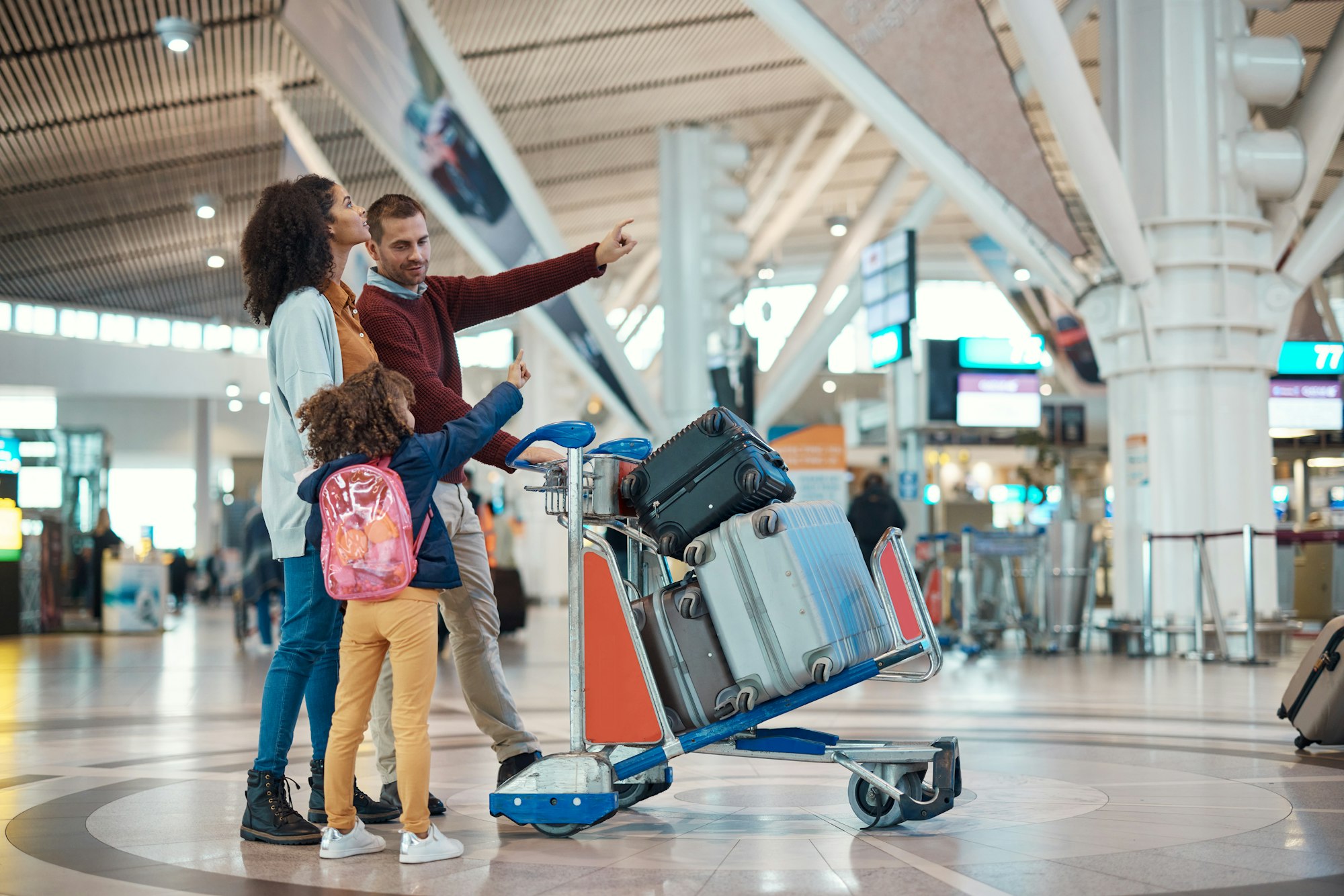 Family at airport, travel and vacation with luggage, mother and father with child, ready for flight